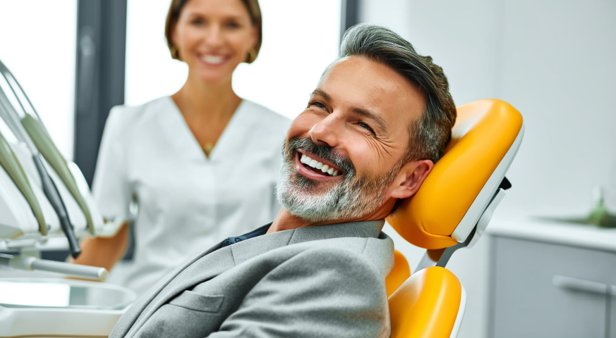 Man smiling confidently after dental implants at a West Palm Beach dental office
