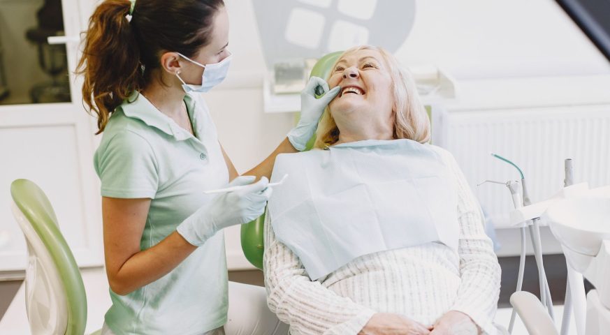 Smiling senior woman with her dentist after an overdentures evaluation in West Palm Beach